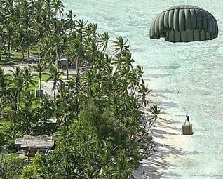 A Christmas supply box, dropped from a C-130E transport plane, floats toward one of the many Islands of Chuuk during a previous Operation Christmas Drop. (Pacific Daily News file photo)
